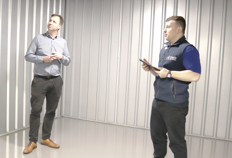 Long term storage Watford. Image shows a Cinch Self storage employee showing a customer the inside of a storage unit. 