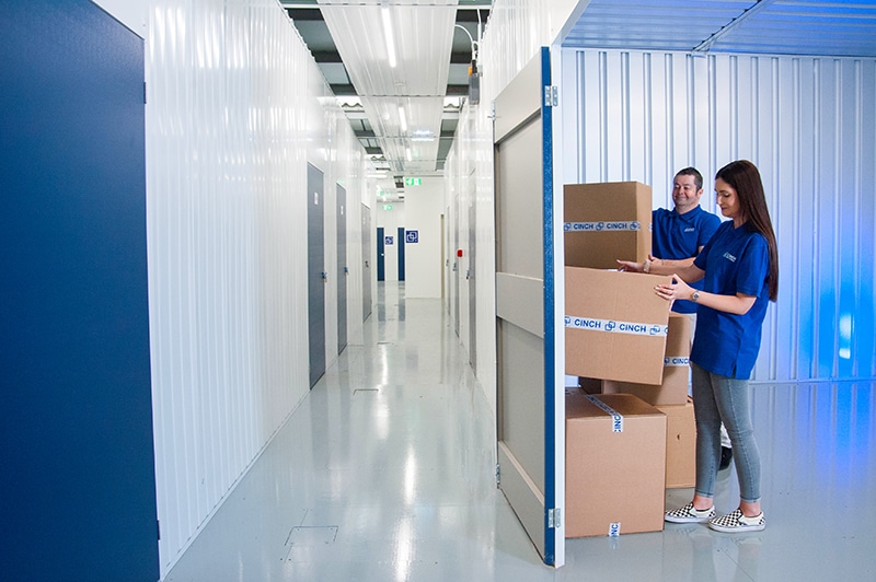 Cinch Storage Edmonton employees handling storage boxes