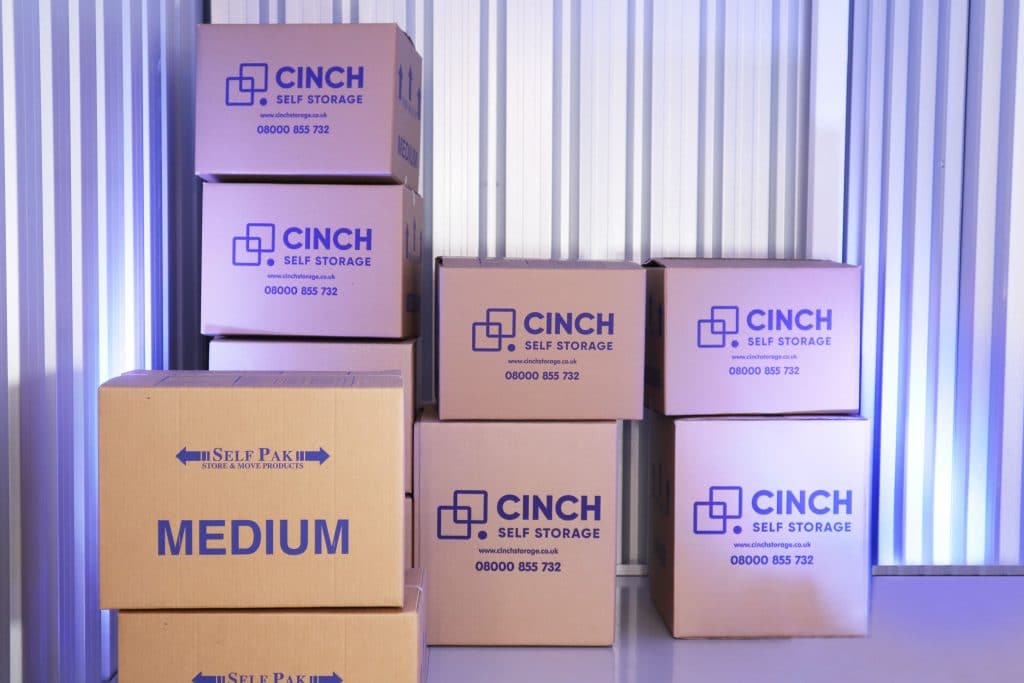 Cinch Storage boxes labelled medium in storage facility stacked up 