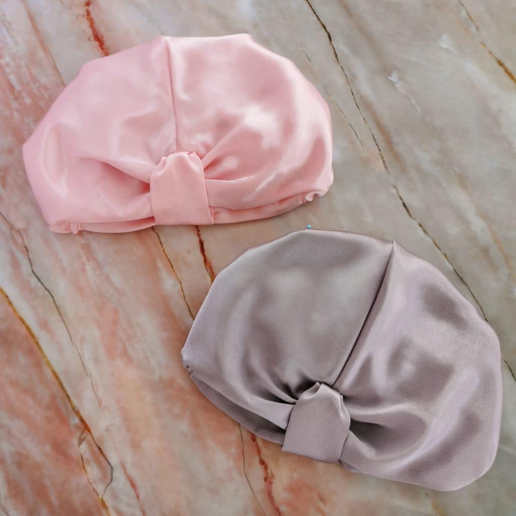 Pink and grey hair accessories against a marble surface