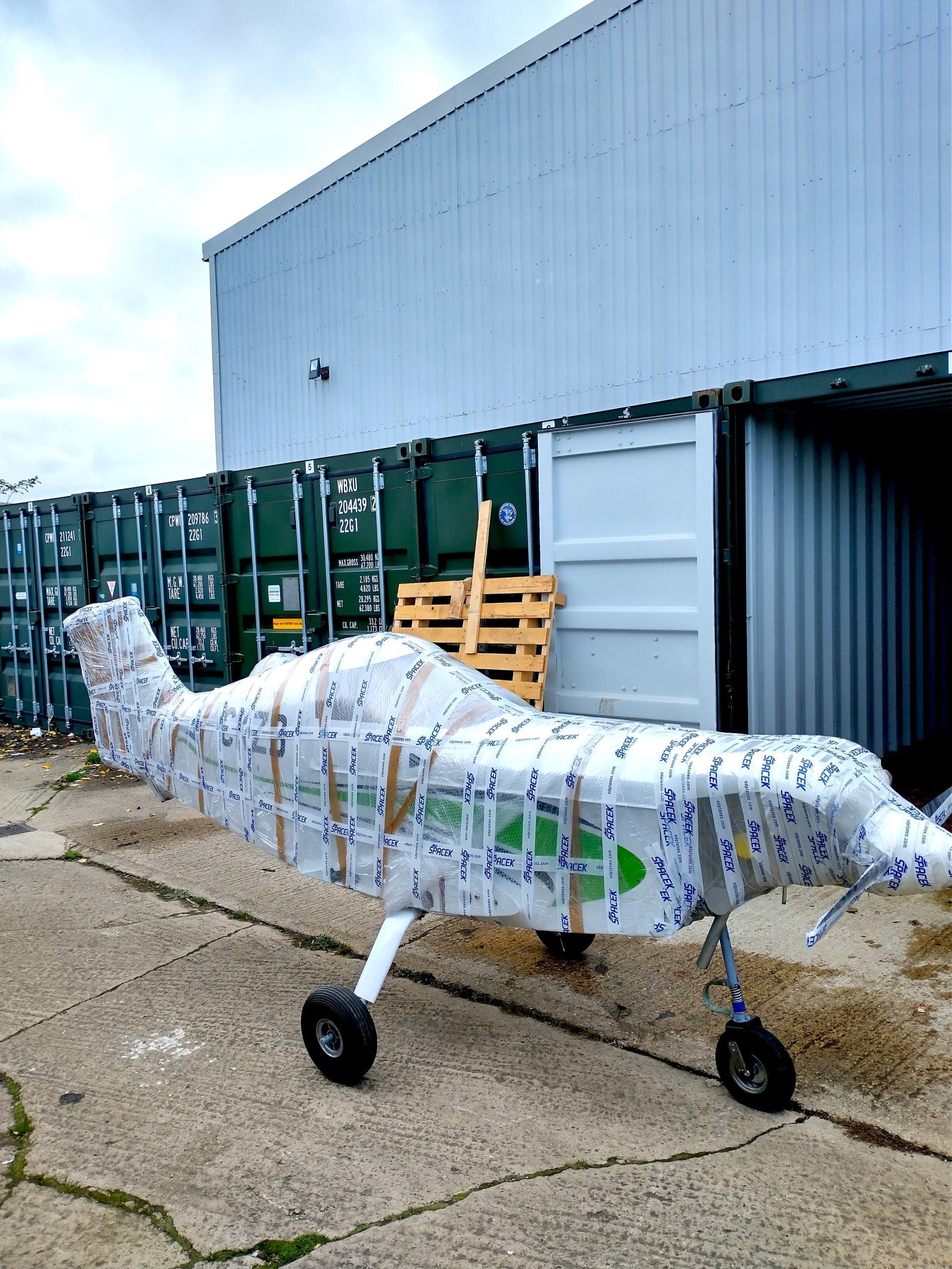 Wrapped up plane outside storage facility