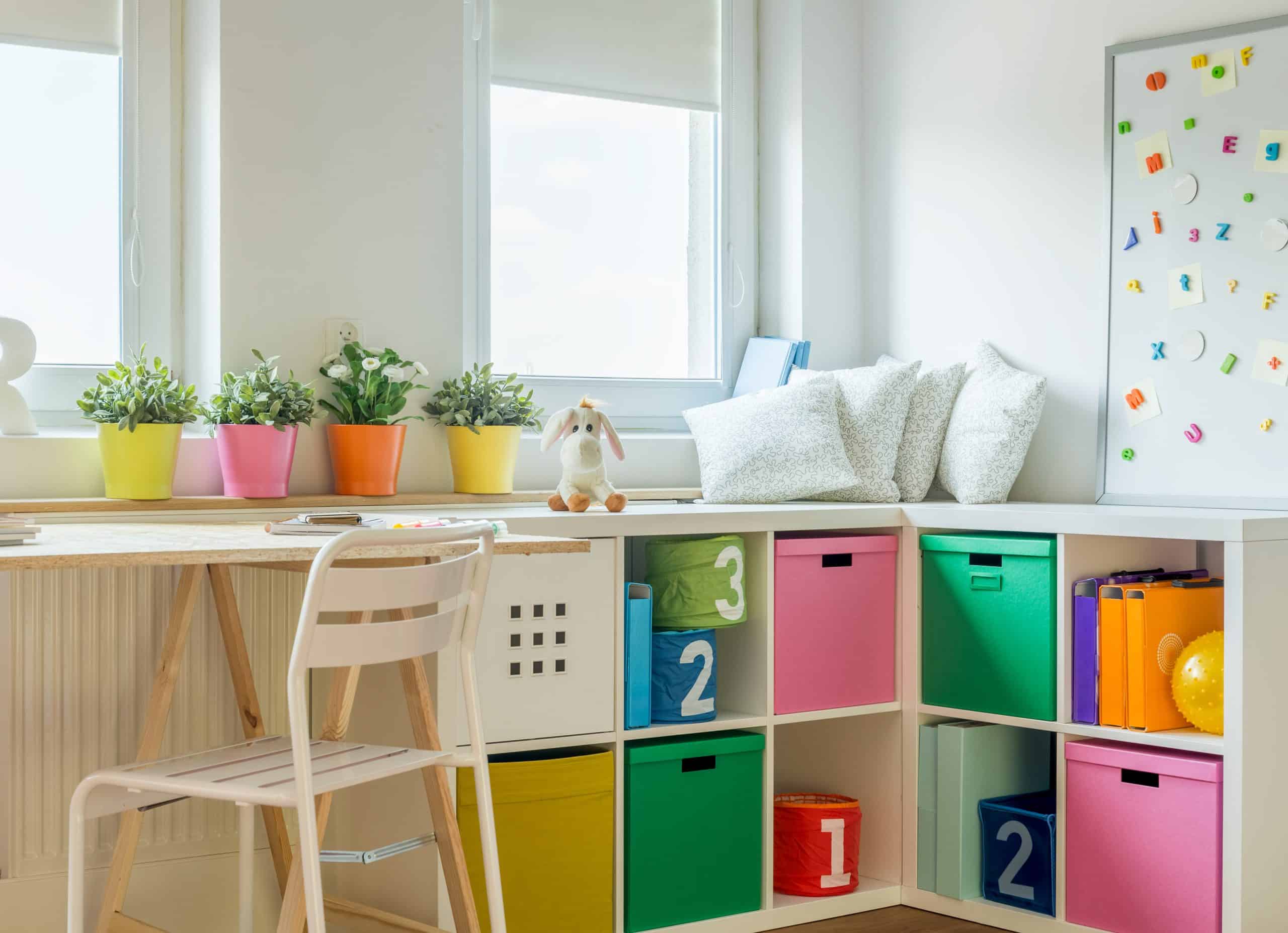 Colourful storage and desk area in corner of well-lit room
