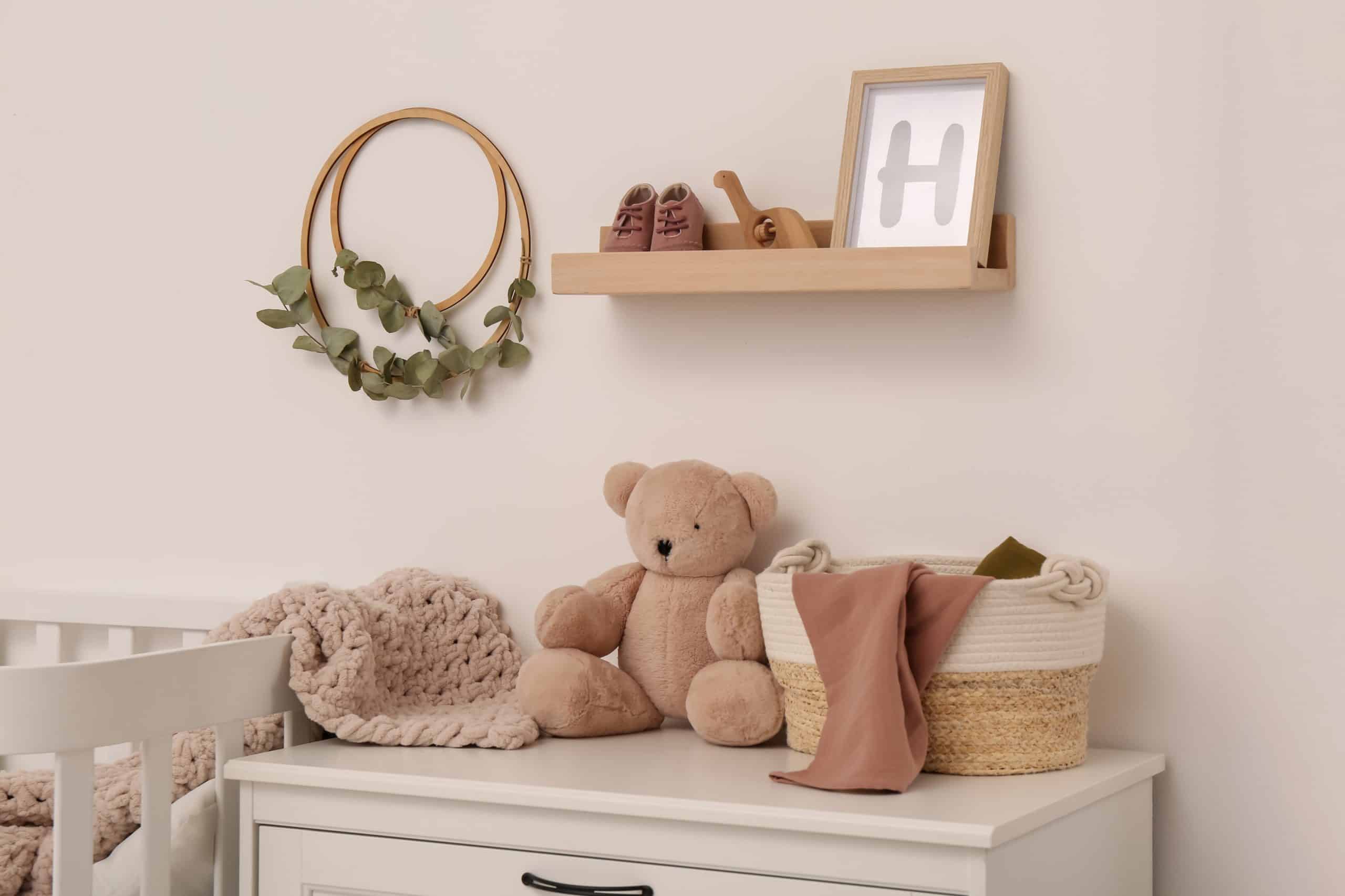 Items of baby furniture spread across the top of a cabinet