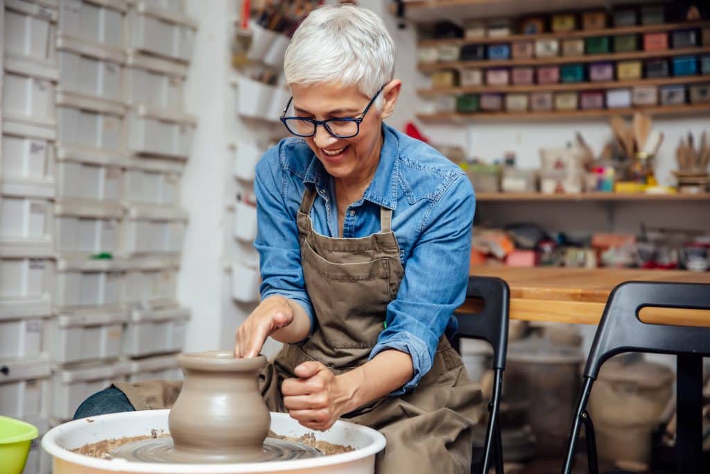 A woman working in her self storage in Hove on her pottery project