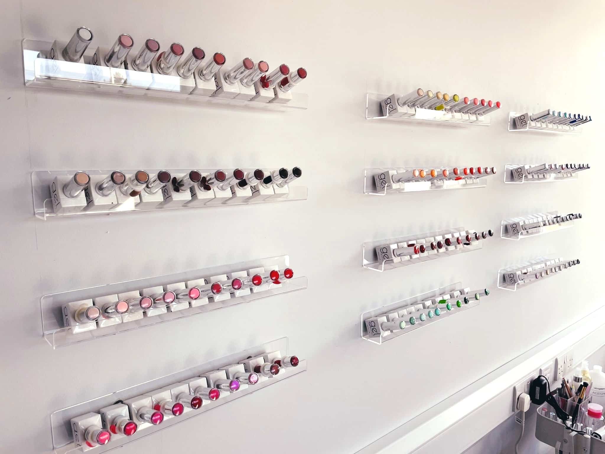 Offices near Enfield - image shows shelves with bottles of nail varnish displayed mounted on a white wall