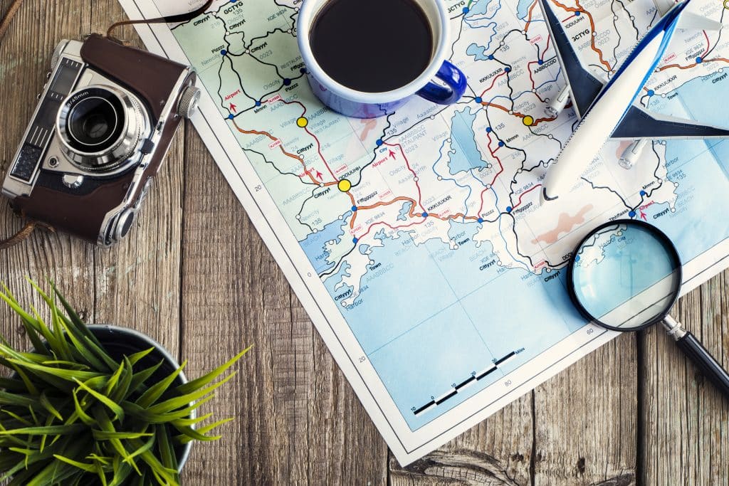 Storage Calne - image shows flatlay of map, blue mug, magnifying glass, camera and green plant