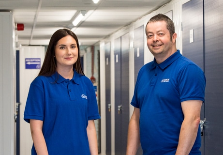 Self storage in Earlsfield: Image shows two Cinch employees standing in the corridor of storage units