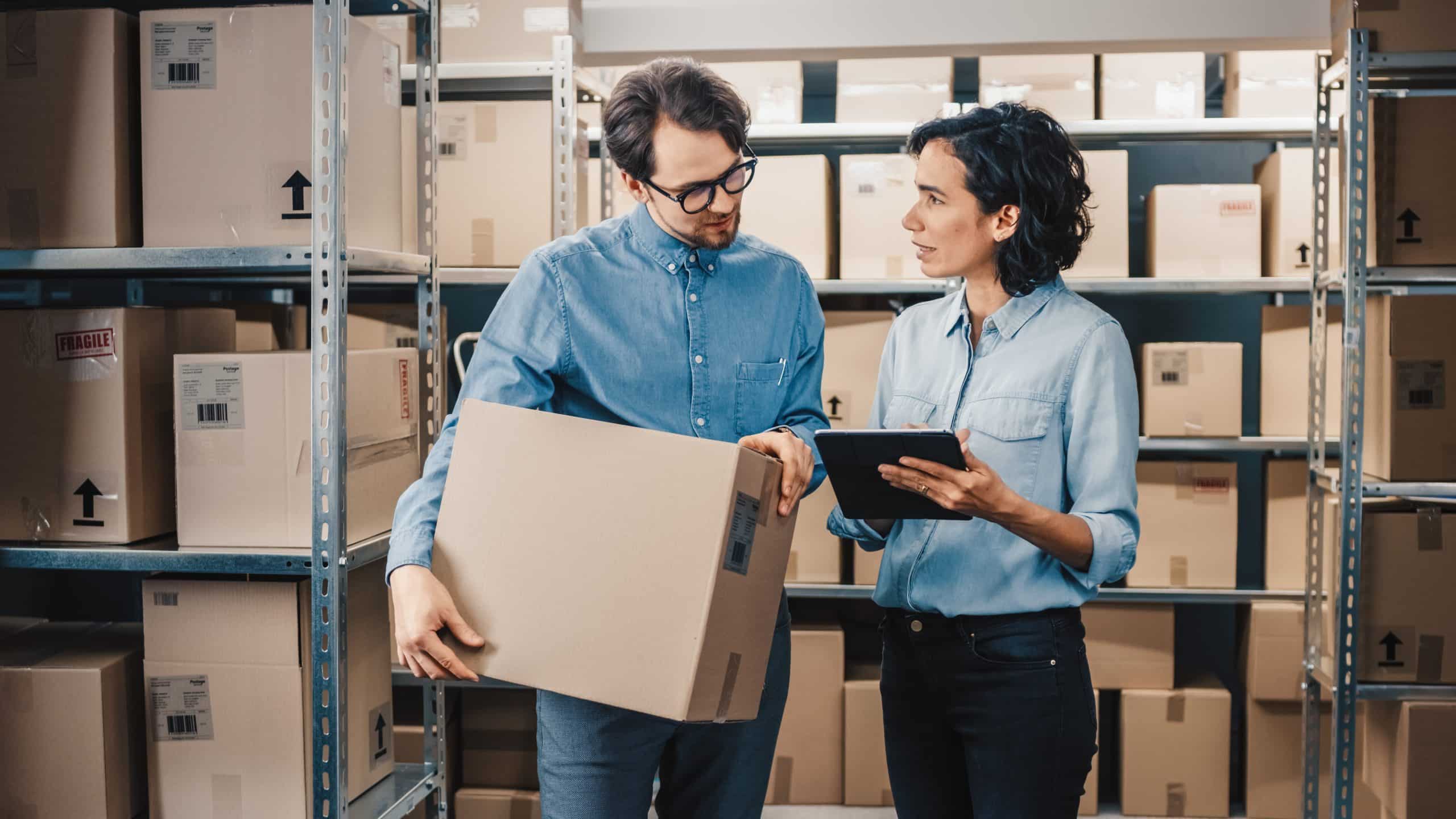 Decided to do big renovations? Our Warehouse Enfield will help. Photograph shows a couple standing in their warehouse discussing and surrounded by their boxes