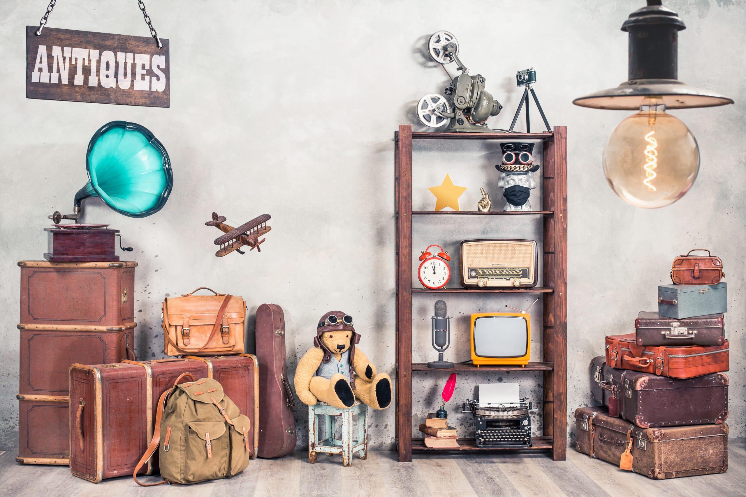 Storage in Newbury: image shows a storage room filled with collectables including a teddy, shelves with clocks and typewriters and an antiques sign