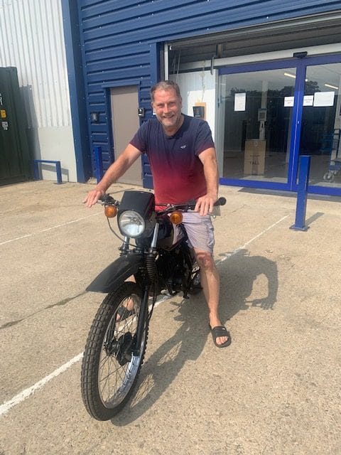 self-storage_bicester_oxon. Image shows cinch self storage customer on his motorbike outside the cinch self storage store in Bicester. 