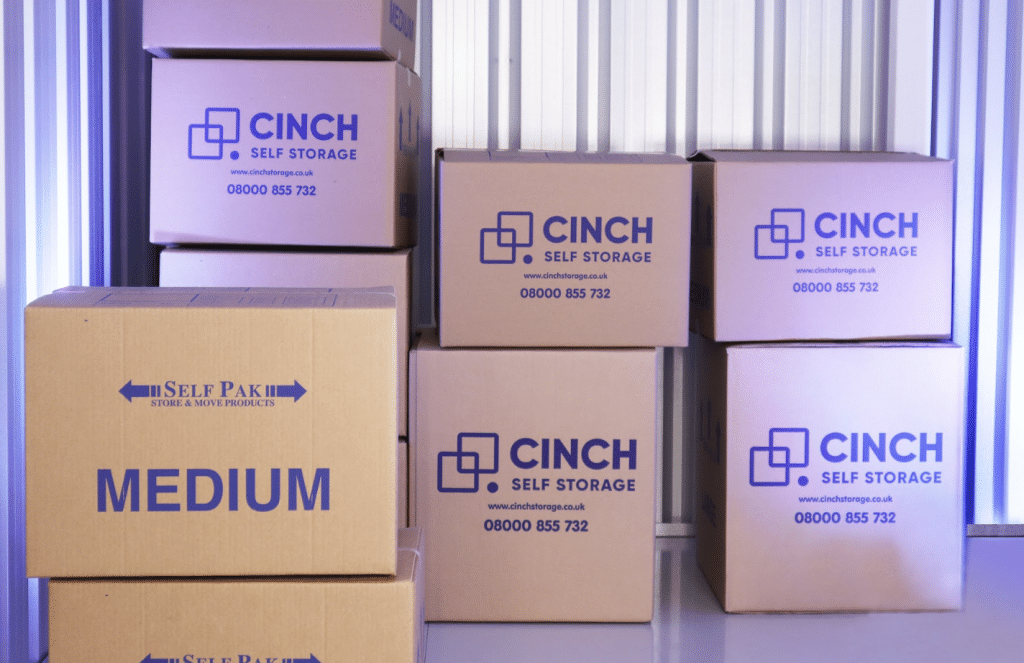 Benefits of long term storage. Image shows the inside of a storage unit filled with branded cinch self storage cardboard boxes.