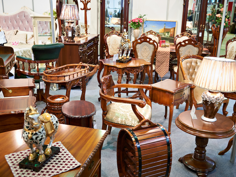 6 Benefits of self-storage for antiques. Image shows antique furniture store with wooden chairs and items.