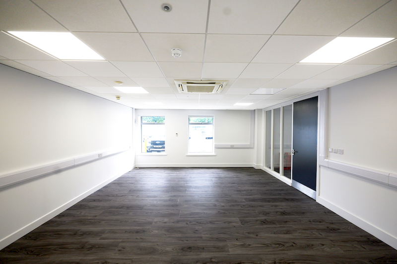 Letchworth Office. Image shows empty office with dark brown wooden floor and white walls.