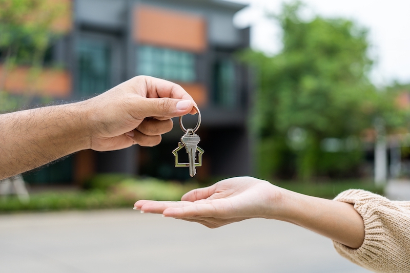 Storage in Woking. Image shows woman being handed a key to her first home.