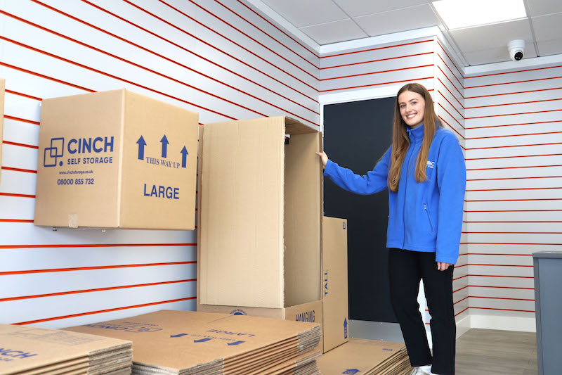 Storage Chingford. Image shows a Cinch Self Storage employee standing in front of the boxshop in reception.