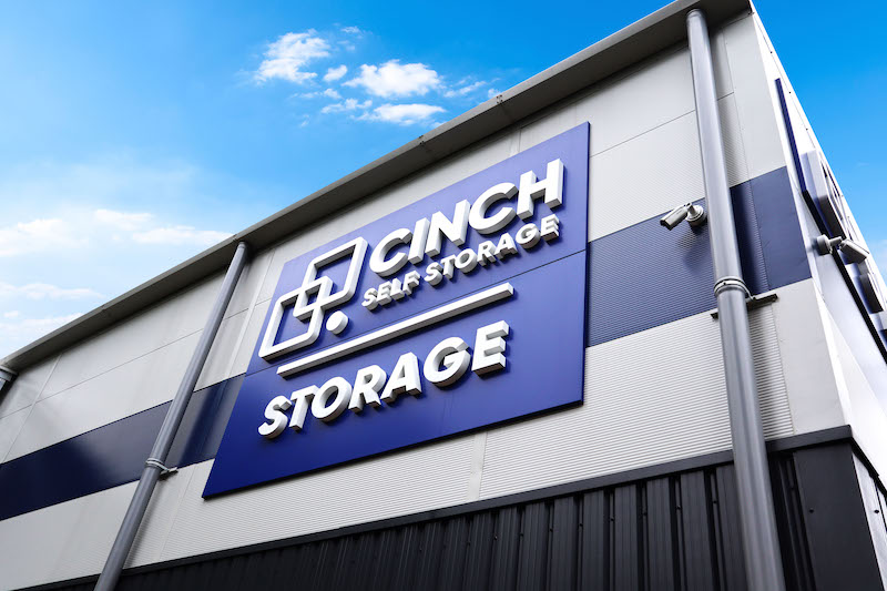 Bedford storage. Image shows external blue Cinch Self Storage sign on exterior of storage facility.