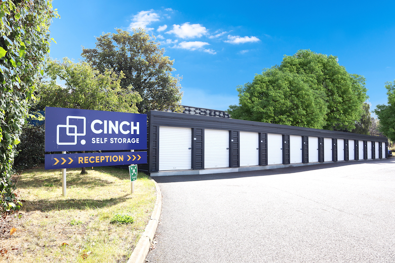 Storage Cranfield. Image shows drive up storage units and a blue cinch self storage sign.