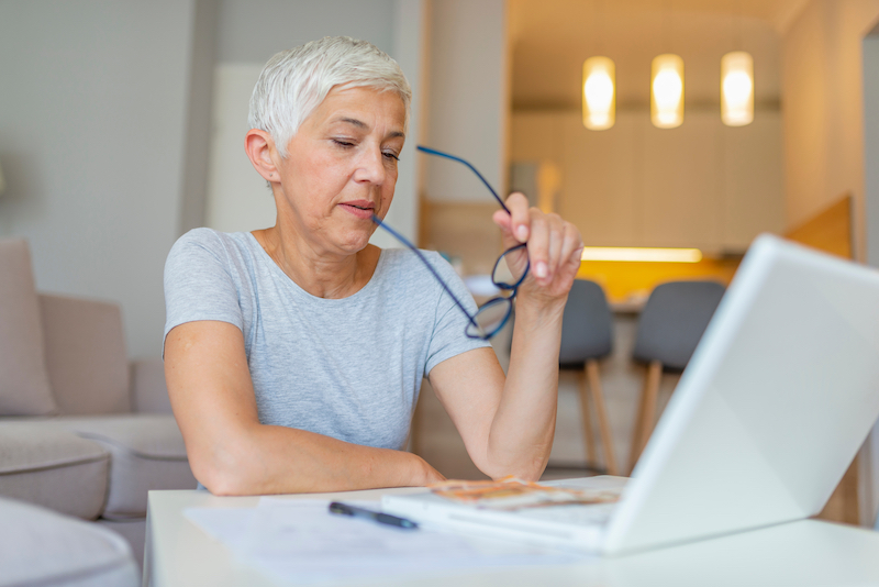 Storage units Gillingham. Image shows lady working from home with her laptop open and blue glasses in her hand.