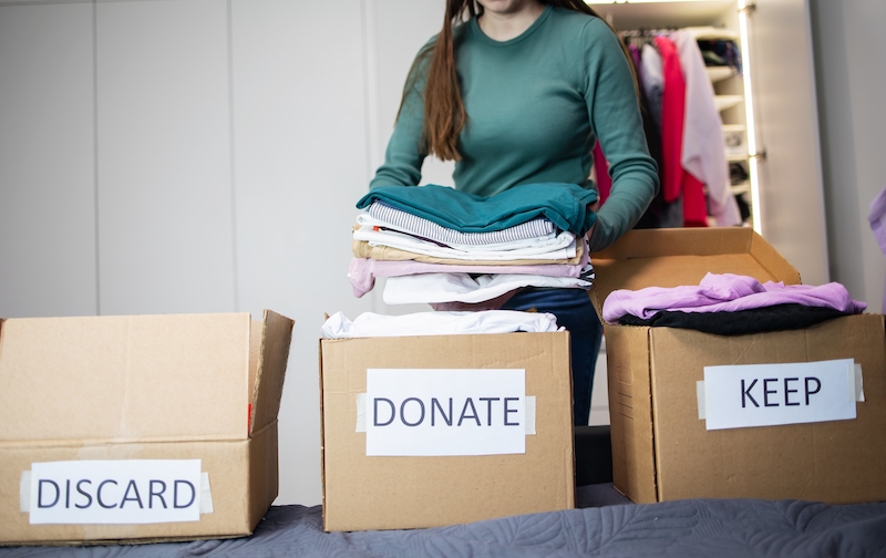 Storage facilities in Earlsfield. Image shows a woman decluttering, using the 4 box method.