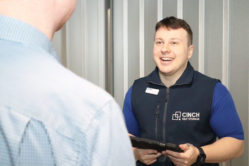 Storage Gillingham. Image shows a Cinch Self Storage employee smiling at a customer.