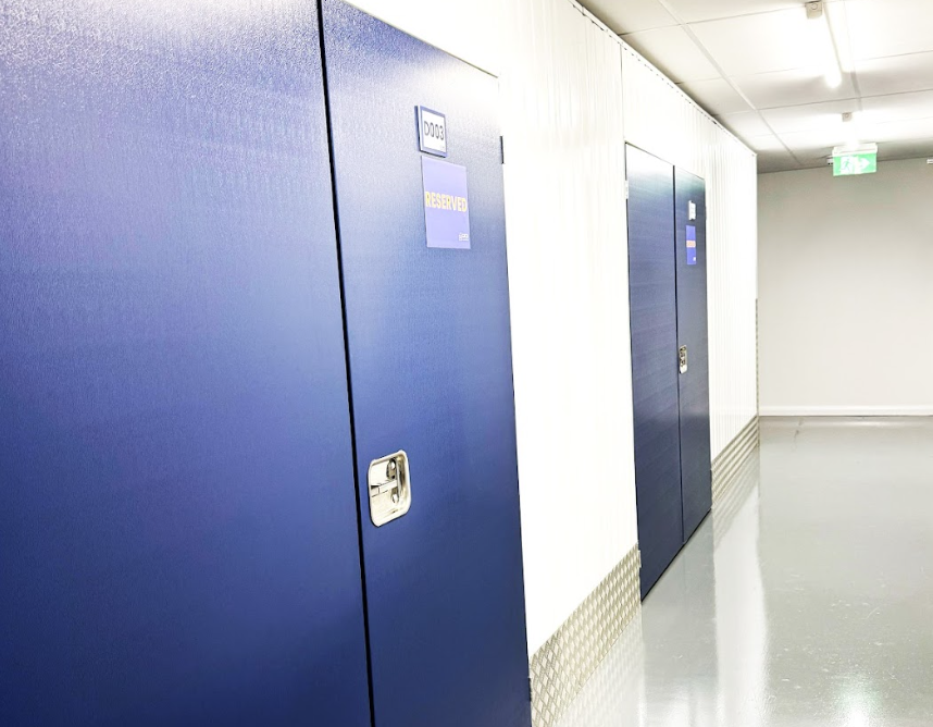 Storage unit in Wisbech. Image shows the internal corridor of a Cinch Self Storage facility with blue doors to storage units.