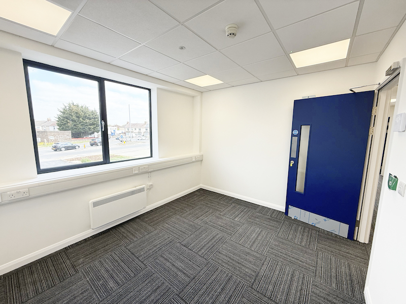 Serviced office London. Image shows the interior of a serviced office with blue door.