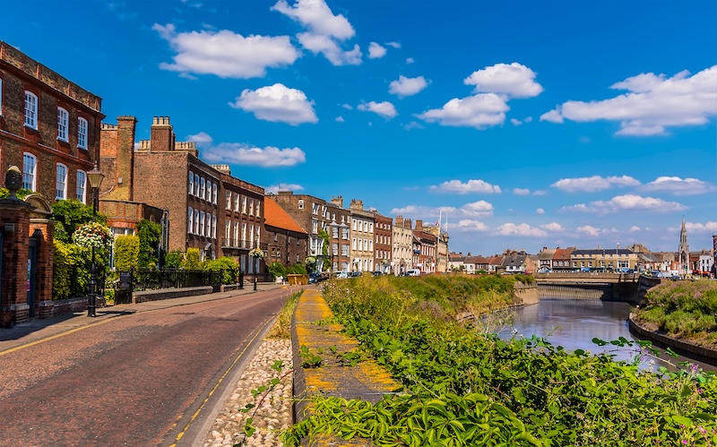 5 things to do in Wisbech. A parade of Georgian buildings on the North Brink beside the River Nene in Wisbech, Cambridgeshire in summertime