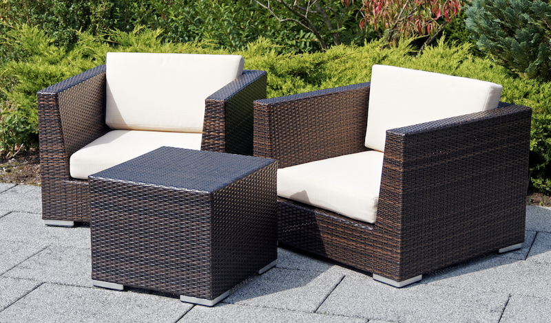 Garden furniture storage. Image shows two outdoor chairs with cushions and a small coffee table that matches the chairs.