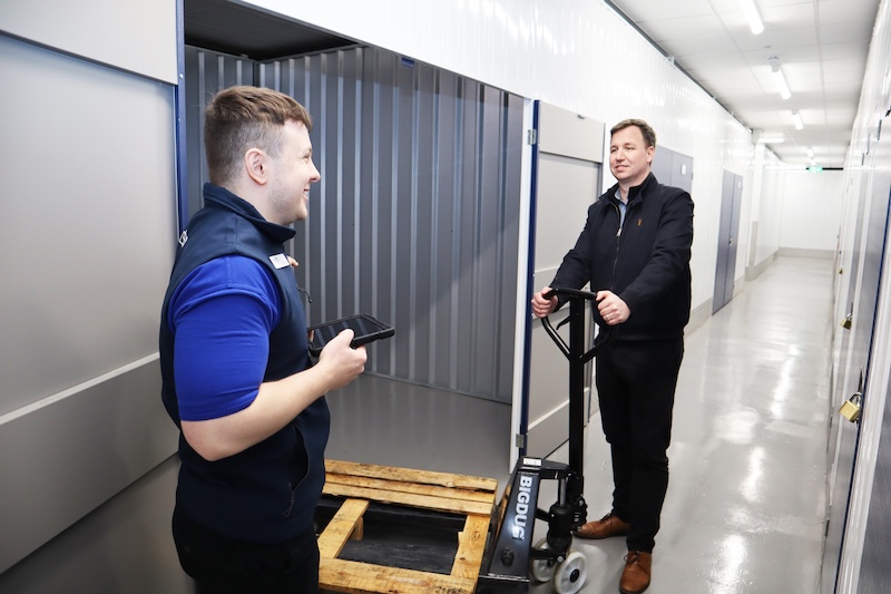 Long term storage in Sittingbourne. Image shows two men standing outside of a storage unit chatting.