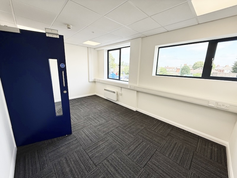 Serviced office in Bicester. Image shows an empty office with blue door at Cinch Self Storage.
