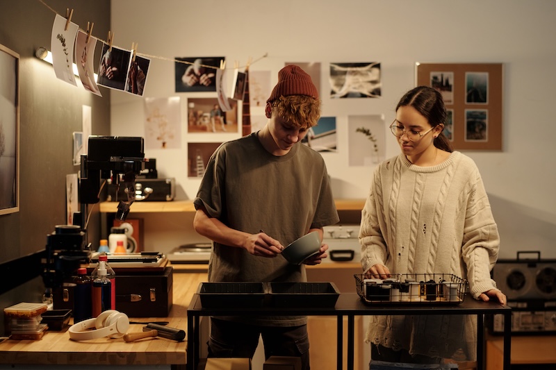 Storage for photographers. Image shows two people working together developing photo prints in their studio