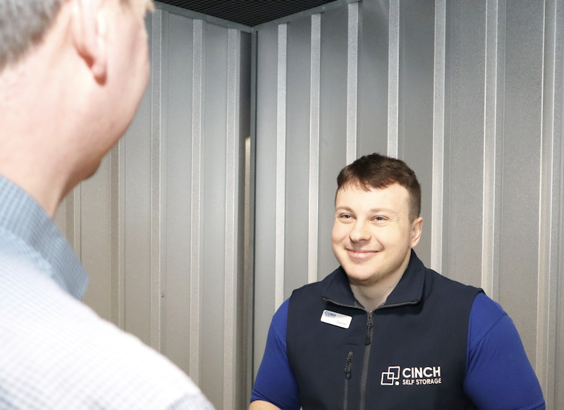 Sidcup short term storage. Image shows a Cinch storage employee inside a storage unit chatting with a customer.