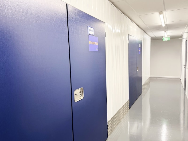 Storage unit in Swindon. Image shows storage unit with blue door and an orange reserved sign on it.