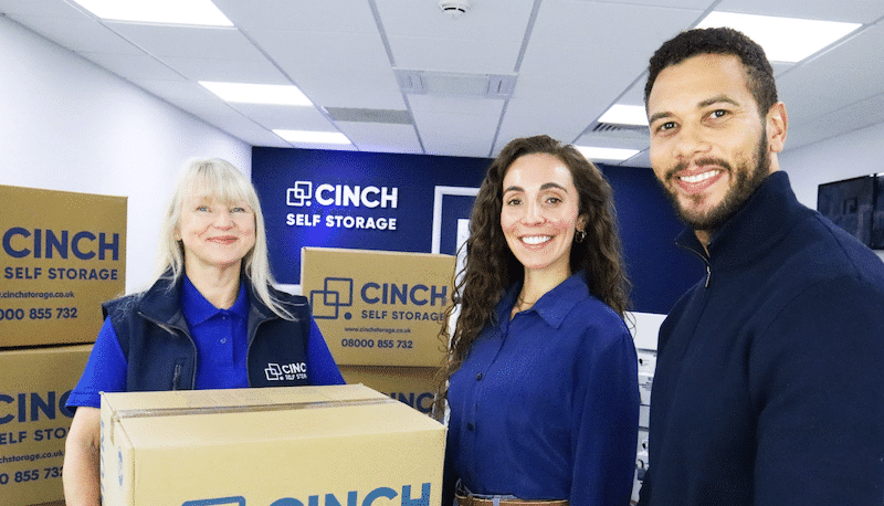 Storage Littlehampton. Image shows a couple and Cinch Self Storage employee holding a box in the Box Shop.