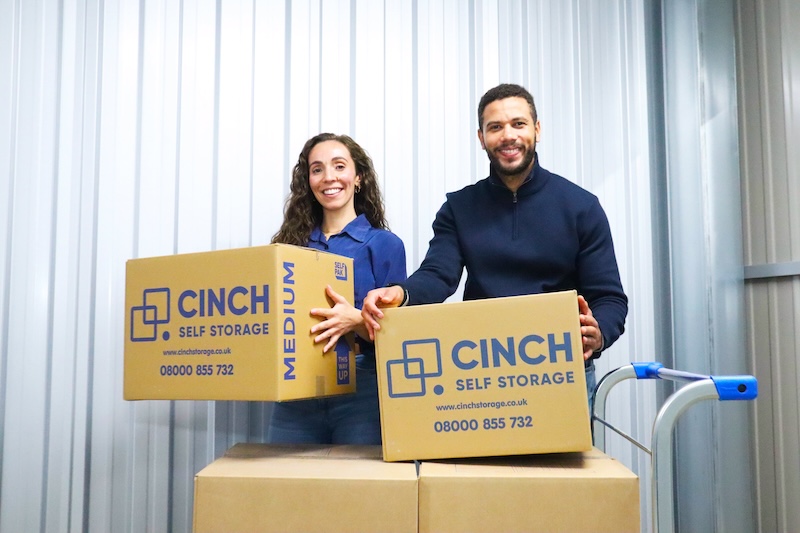 Storage Newcastle. Image shows a man and a woman unloading Cinch Self Storage cardboard boxes into their storage unit.