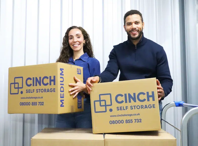 Storage in Paulton. Image shows a couple unloading Cinch Self Storage cardboard boxes into their storage unit.