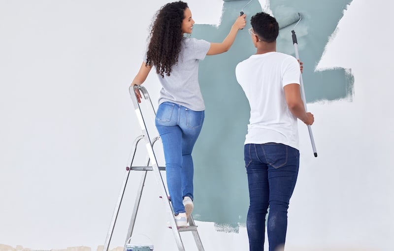 Storage rooms Paulton. Image shows a couple painting a wall when renovating their house.