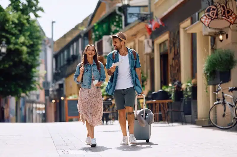 Storage unit Newcastle. Image shows a couple walking down a mediterranean street whilst travelling.