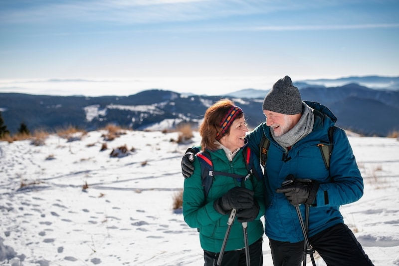 Storage units in Paulton. Image shows an older couple enjoying a snowy hike in their hiking gear.