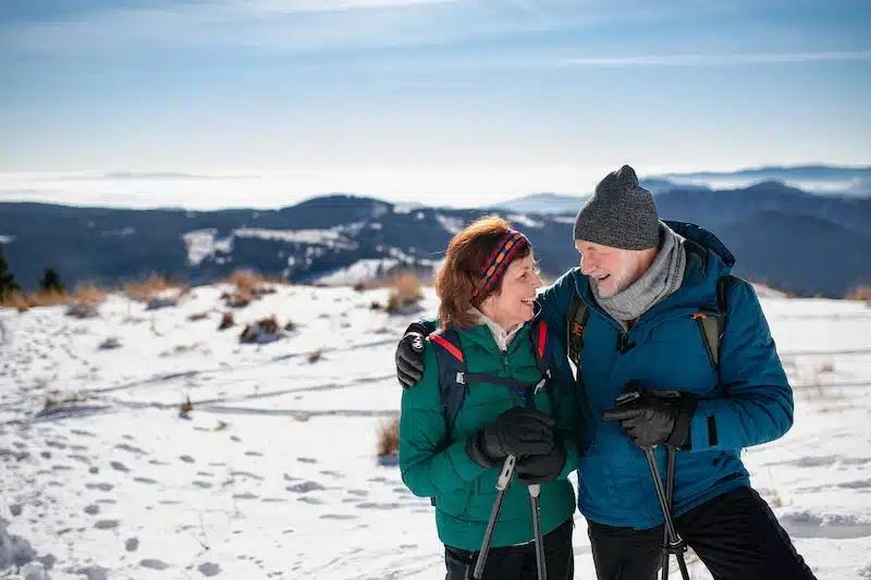 Storage units in Paulton. Image shows an older couple enjoying a snowy hike in their hiking gear.