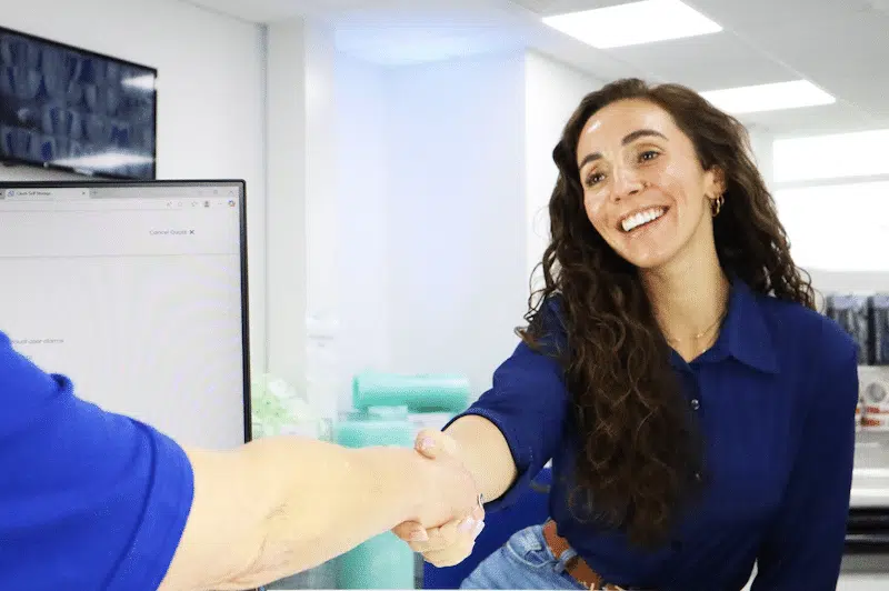 Storage facilities Newcastle. Image shows a woman shaking hands with a Cinch Self Storage employee after securing her storage unit.