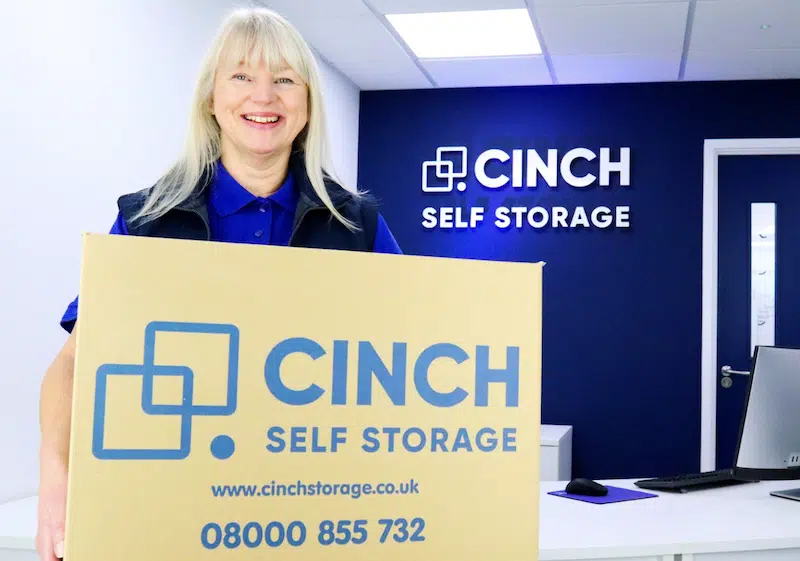 Storage near Shoreham. Image shows a Cinch Storage employee holding a branded Cinch Storage cardboard box.