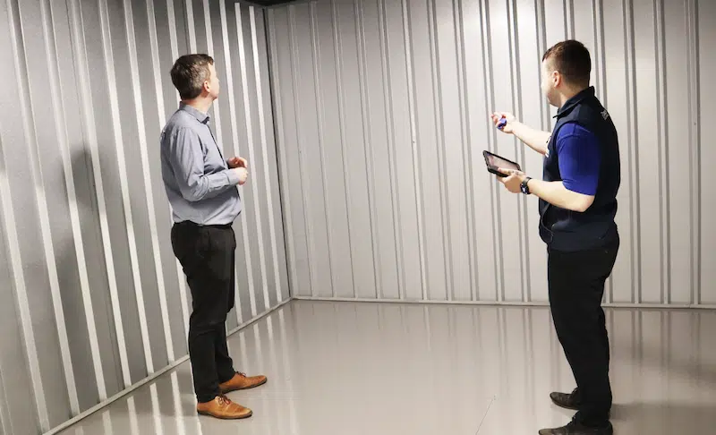 Storage rooms Watford. Image shows a Cinch Storage employee showing a customer around a storage room. 
