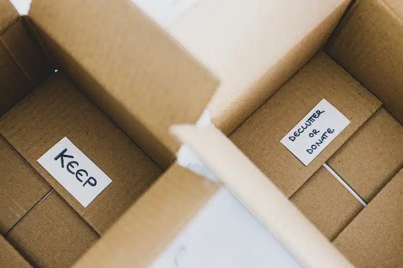 Storage to rent Brighton. Image shows two empty cardboard boxes. One with a label that says 'Keep' and the other that says 'Declutter or donate'. 