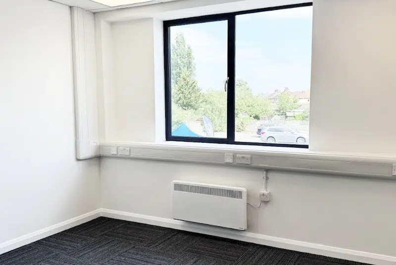 Office space to rent Chippenham. Image shows an empty Cinch Self Storage office space with large window. 