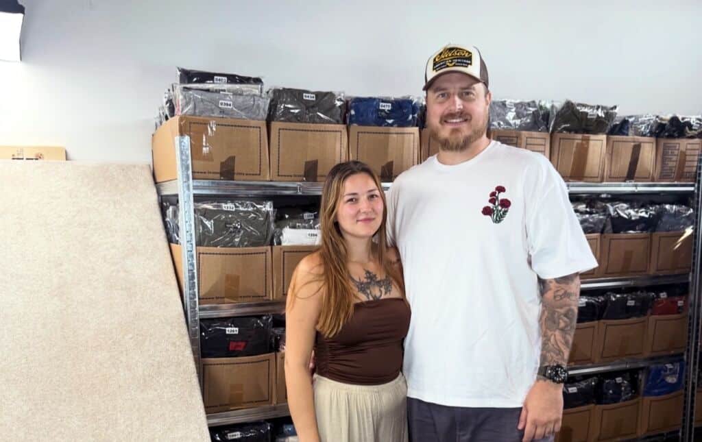 East Coast Apparel. Image shows founders Curtis and Beck inside their storage unit at Cinch Self Storage.